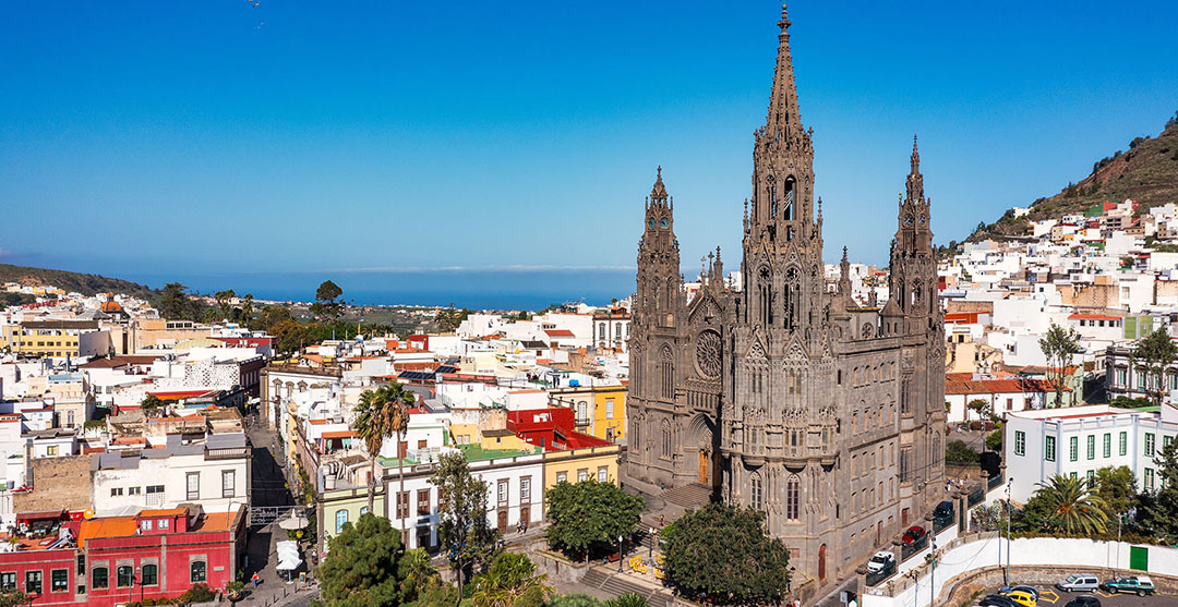 Aerial view of the Parroquia de San Juan Bautista de Arucas church in Arucas town, Gran Canaria, Canary Islands, Spain. Historic Neo-Gothic cathedral in Arucas. Aerial view of the Parroquia de San Juan Bautista de Arucas church in Arucas town, Gran Canaria, Canary Islands, Spain. Historic Neo-Gothic cathedral in Arucas.