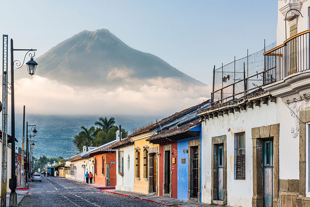 Old town in Antigua Guatemala with the volcano fire antigua guatemala digital nomads