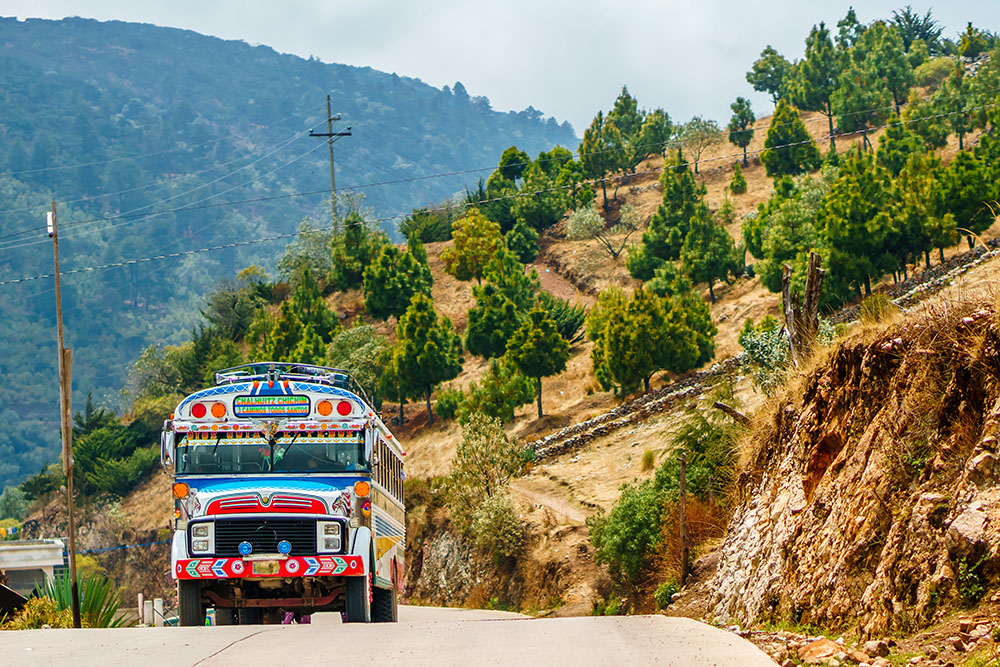 Old school bus used as public transport by Todos Santos Cuchumat colorful bus guatemala